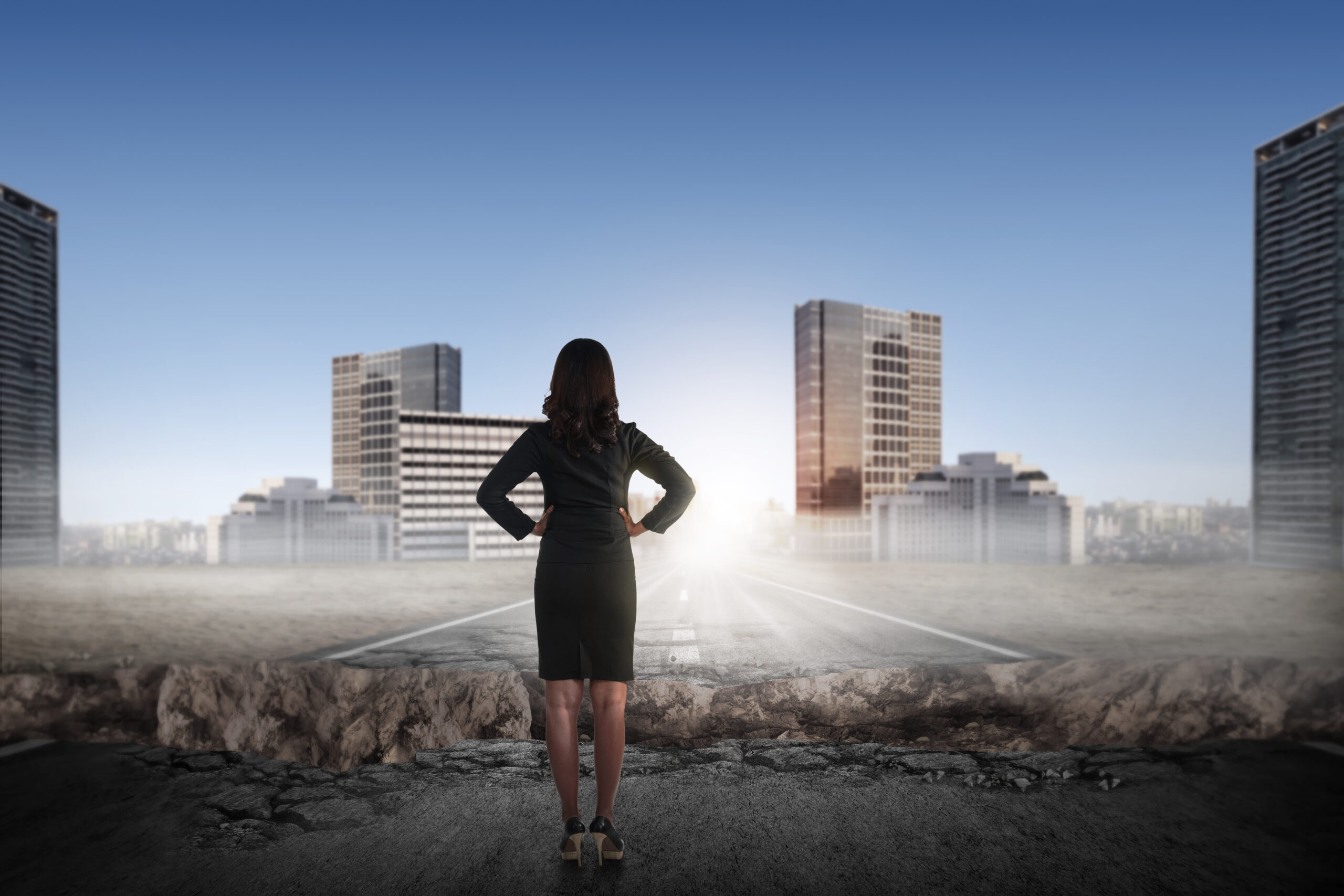 Asian business woman looking the city from broken road