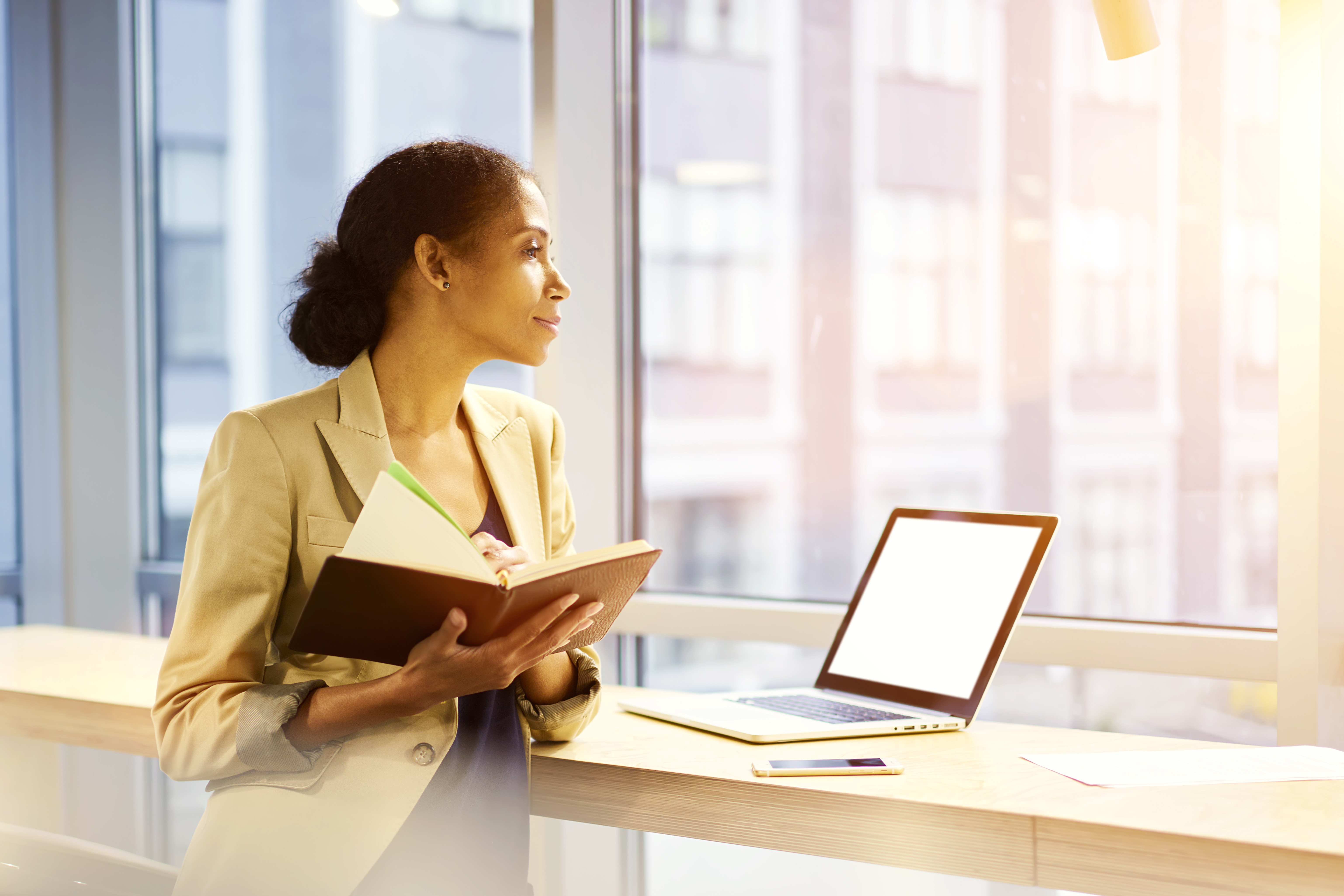 Joyful female entrepreneur happy to finishing work on successful media marketing startup making presentation about company development using laptop computer with mock up screen connected to wifi