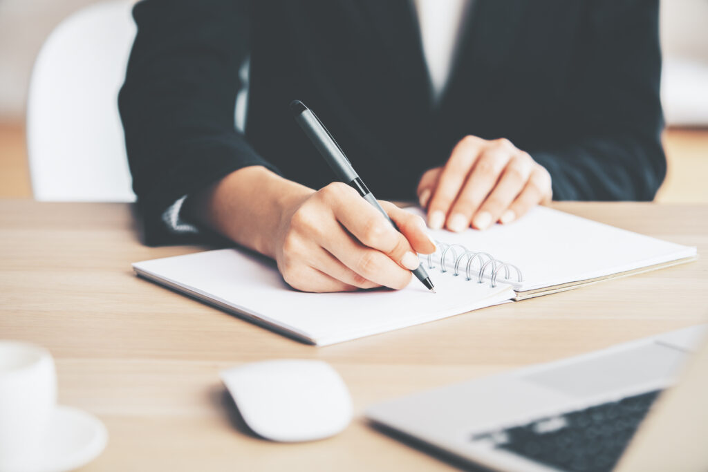 Girl writing in notepad