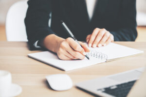 Girl writing in notepad