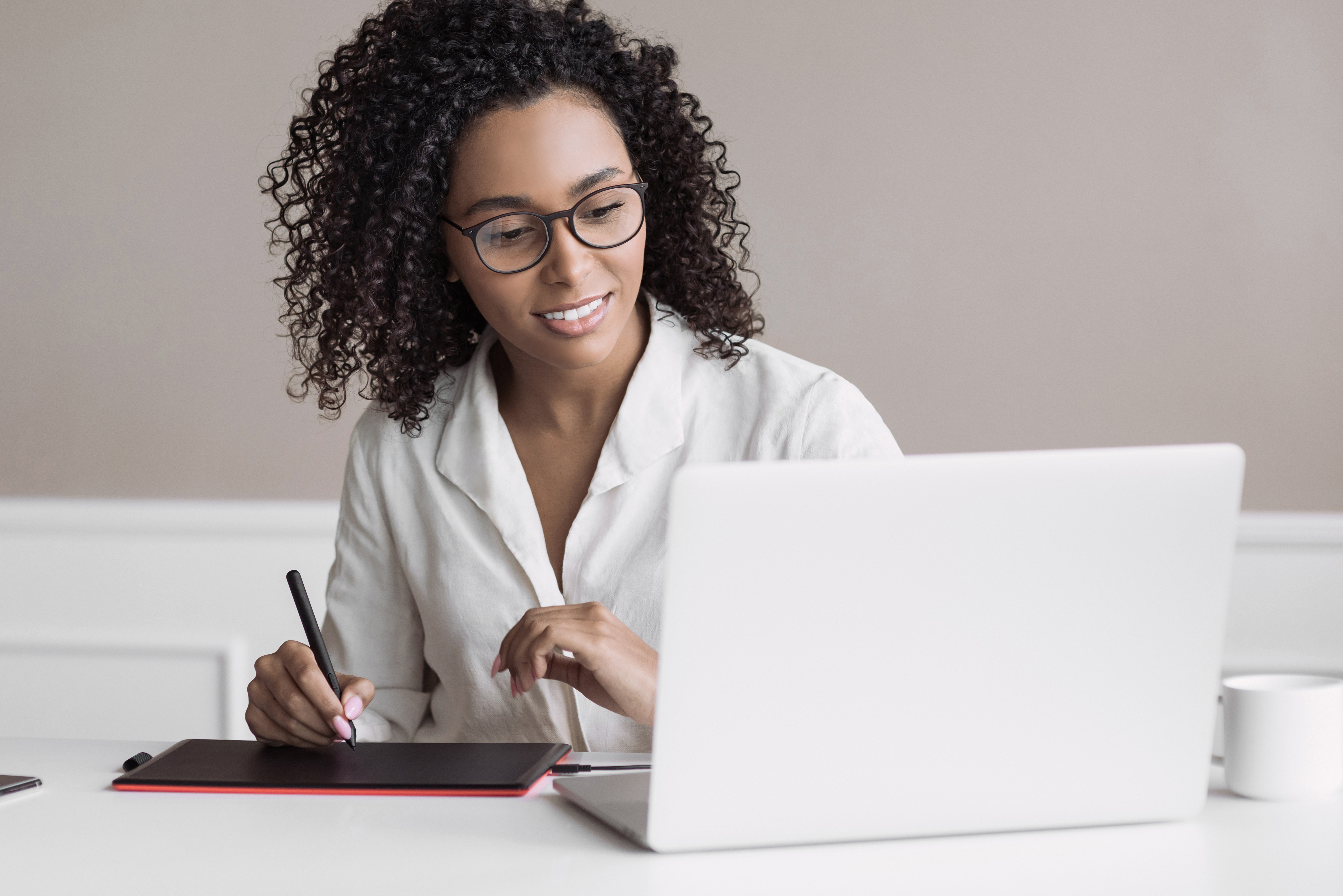 Young woman using laptop computer at office. Student girl working at home. Work or study from home, freelance, business, lifestyle concept