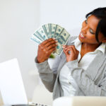 Happy woman looking to dollars