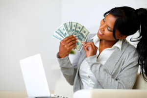 Happy woman looking to dollars