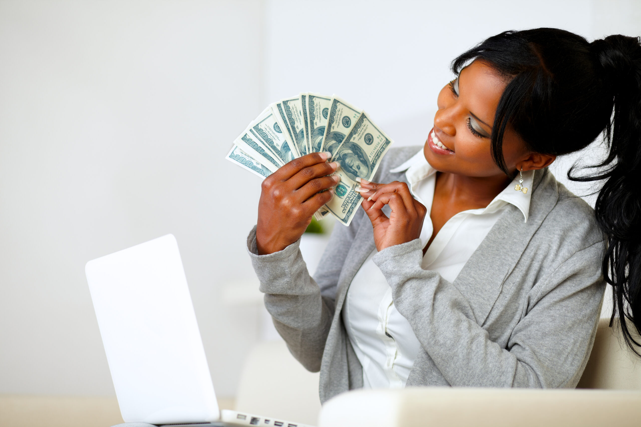 Happy woman looking to dollars